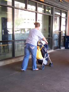 Mother and son walk the length of the transit center, waiting on the buses